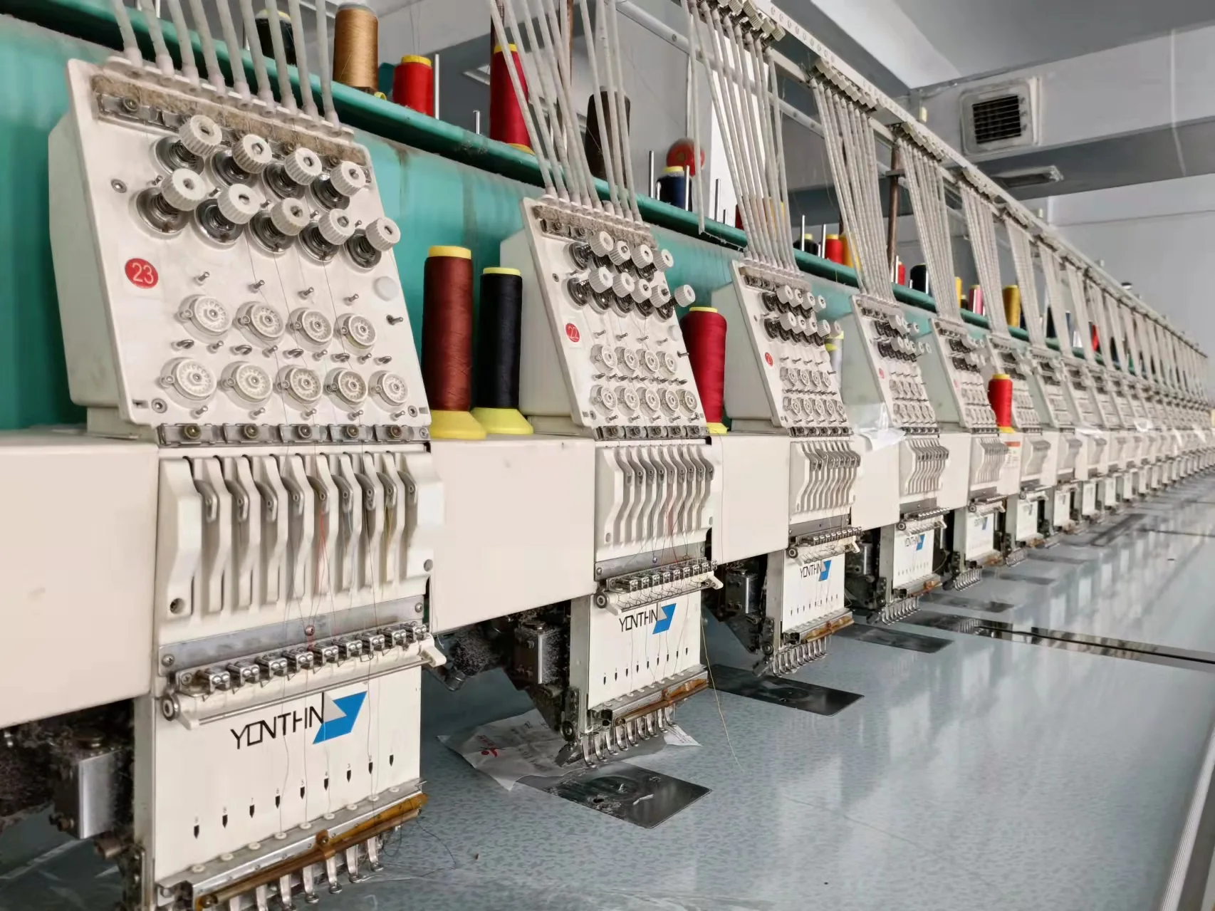 Multi-head embroidery machines for custom hotel linens