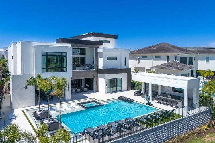 A large guest property with a pool and multiple outdoor spaces